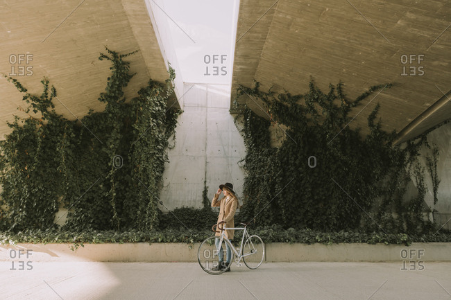 Young hipster woman with a bicycle