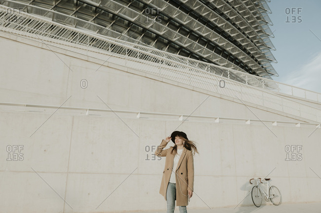 Young hipster woman in modern background with earphones