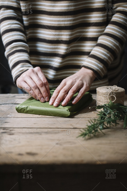 Woman's hands wrapping present - Offset