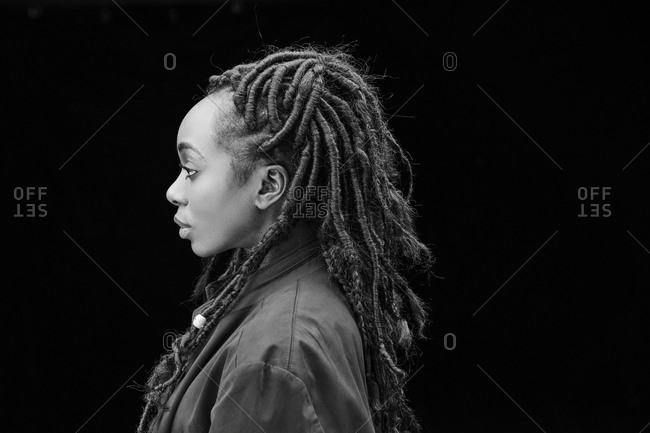 Profile Of Woman With Dreadlocks In Front Of Black