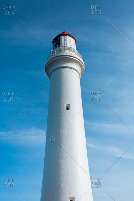 Traditional lighthouse against a bright blue sky