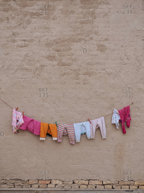 Clothesline drying clothing on side of building in a city in Uzbekistan
