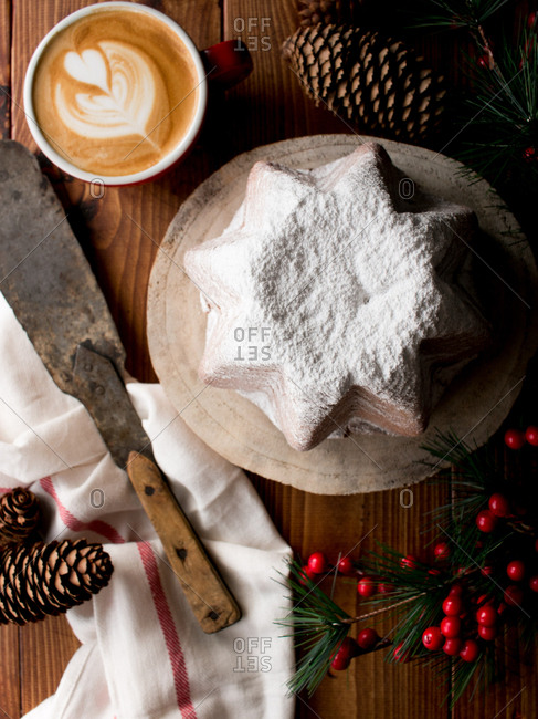 Set of dried autumn leaves and cloth napkins placed on lumber tabletop near bowl with yummy pumpkin hummus with seeds and sesame