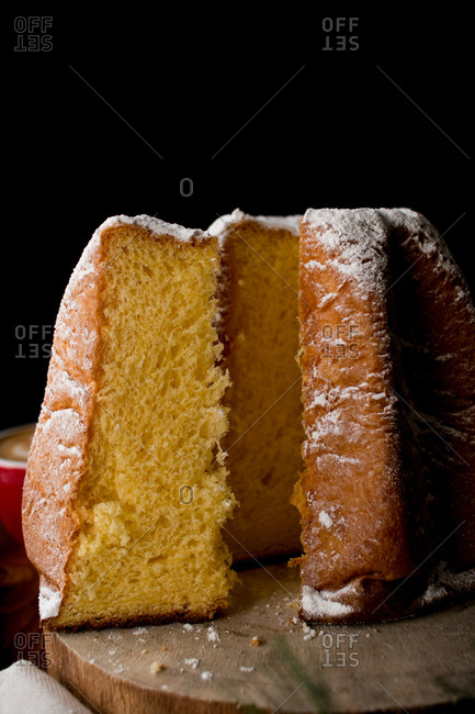 Set of dried autumn leaves and cloth napkins placed on lumber tabletop near bowl with yummy pumpkin hummus with seeds and sesame