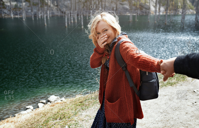 Playful couple having fun at the lake with submerged trees