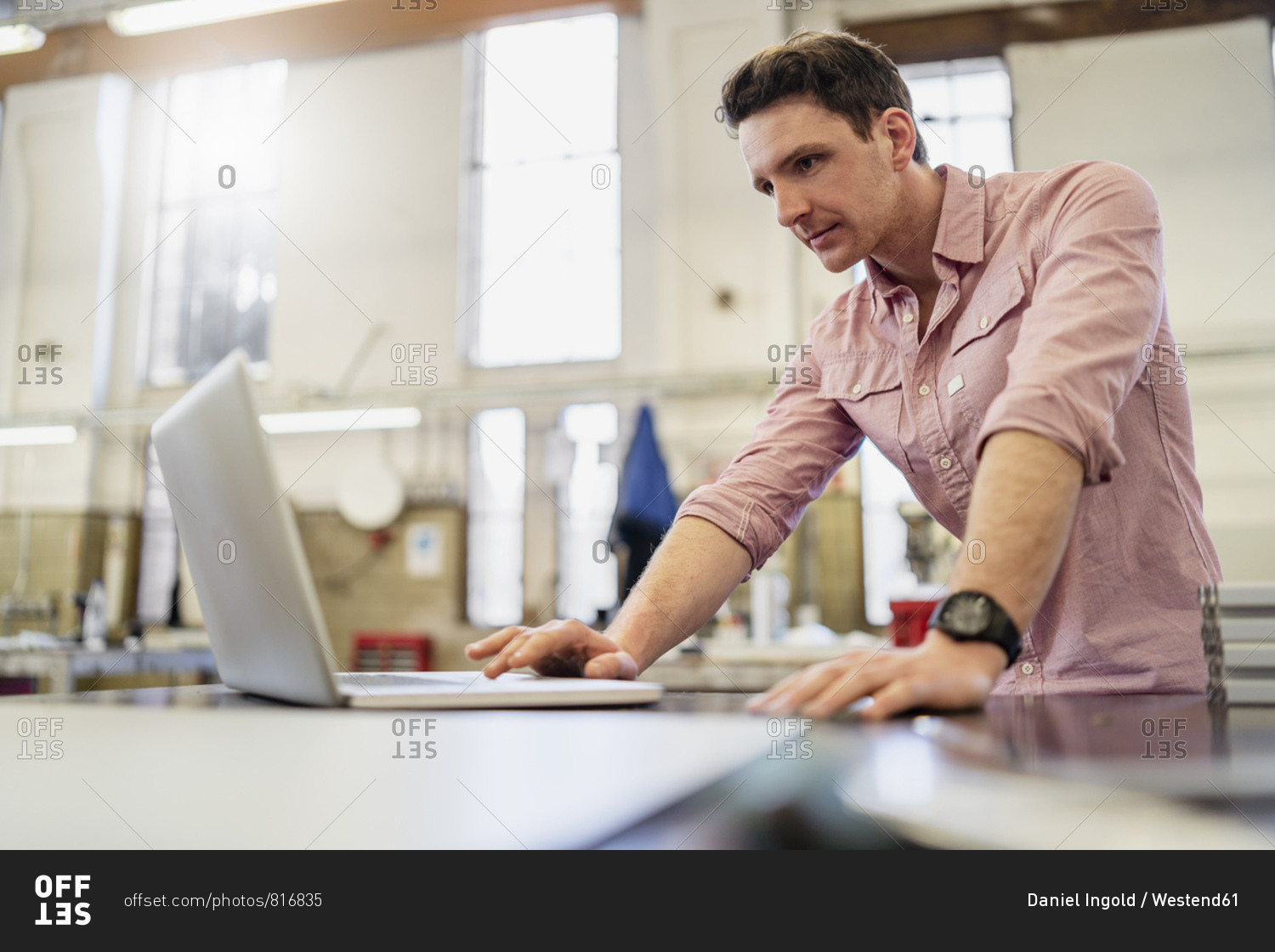 Man using laptop in factory