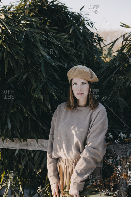Portrait of fashionable woman wearing beret in the garden
