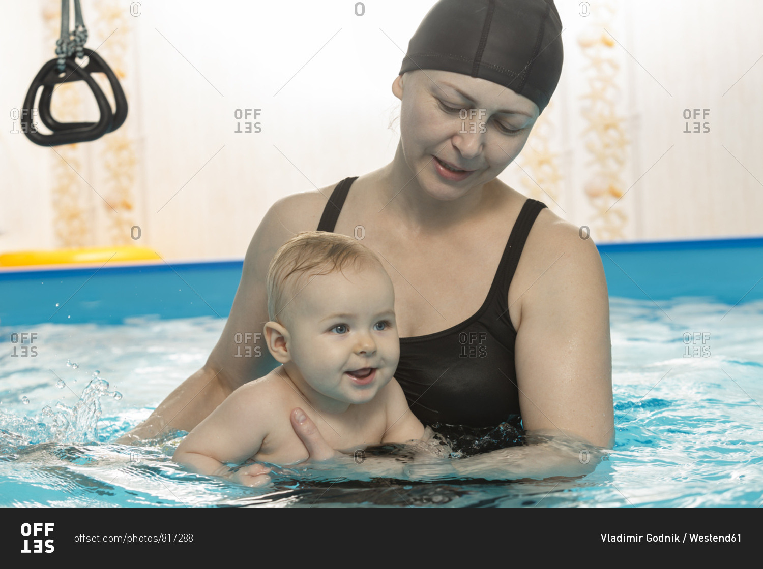 Baby swimming- mother with daughter in swimming pool