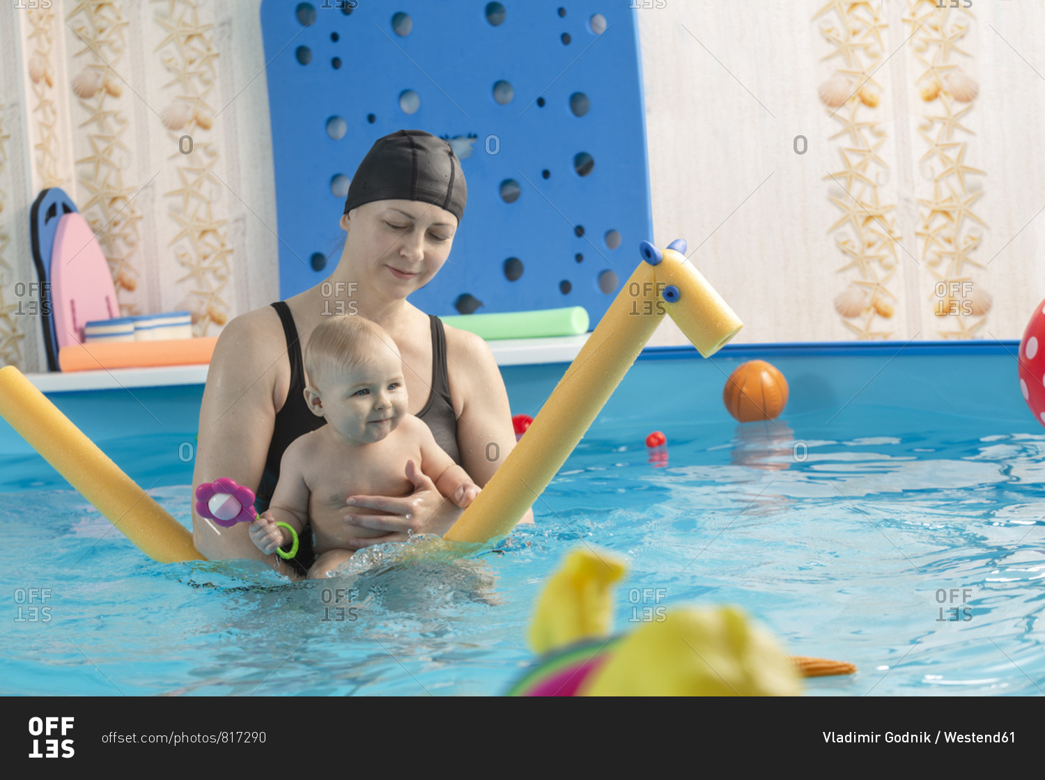 Baby swimming- mother with daughter in swimming pool