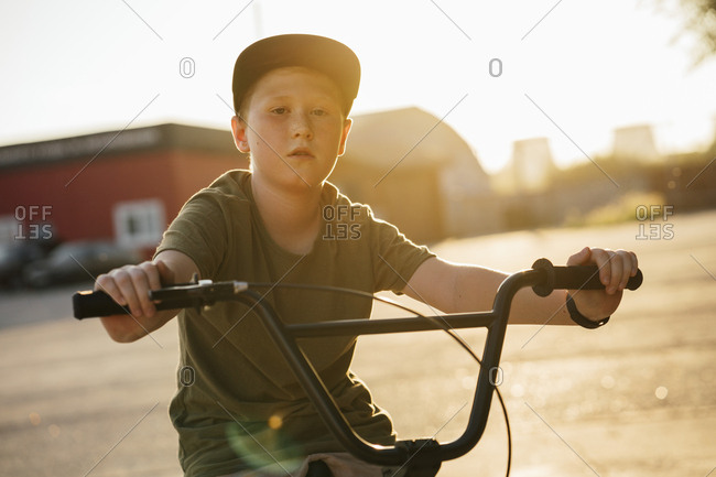 Portrait of serious boy with bmx bike