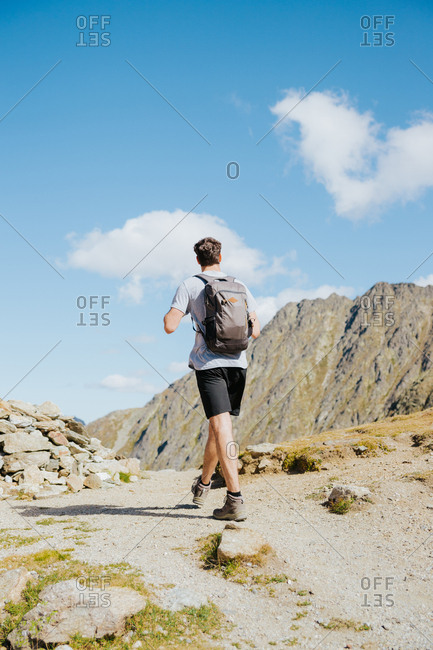 Man hiking a mountain in Andorra during summer