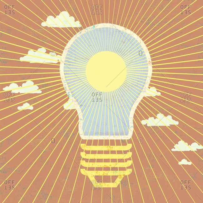 Outline of a light bulb with sun and rays against a sunrise