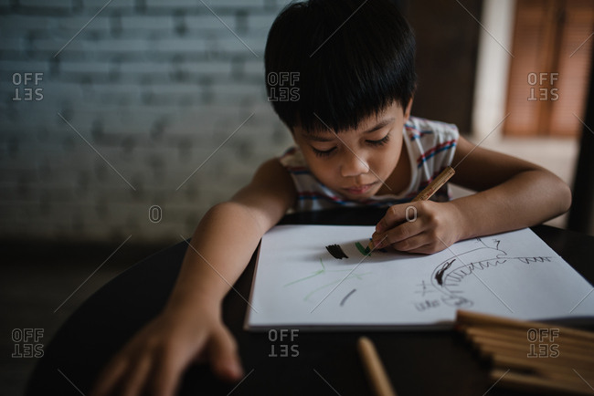 Young Asian boy drawing a picture