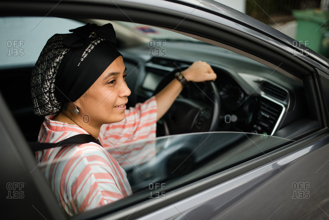 Asian woman driving car - Offset