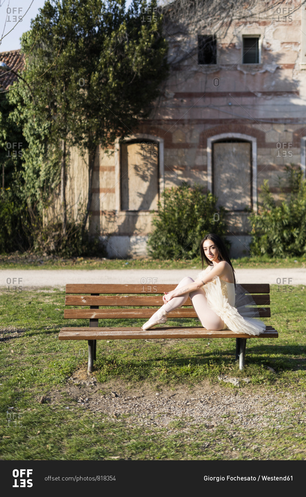 Italy- Verona- portrait of ballerina sitting on bench in the city