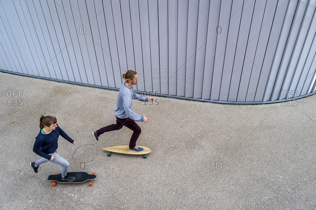 Young couple longboarding- seen from above