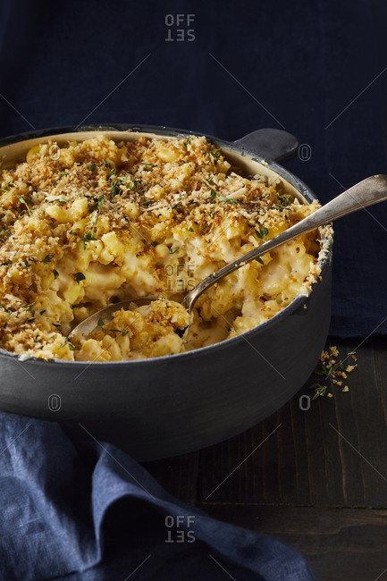 Large serving bowl of  macaroni and cheese with breadcrumb and herb crust