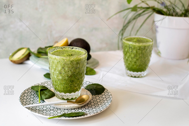 Healthy green smoothie - spinach, avocado and kiwi apple with lemon juice. Super food, detox and healthy food.