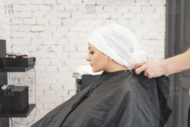 Stylist washing hairs to young lady