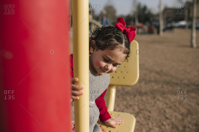 Little Girl With Curly Hair Is Playing In A Park Stock Photo Offset