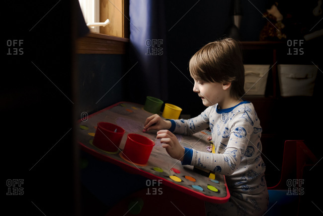 A Small Boy Making Artwork On A Chalk Board