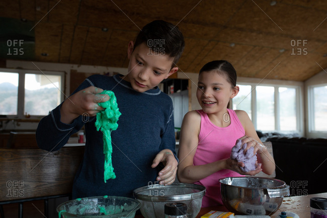 Kids laughing while playing with the slime they made