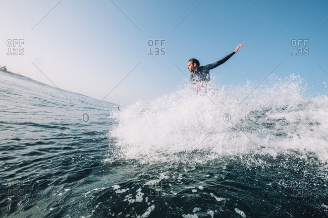 Canary Islands - May 15, 2019: A surfer takes off on a wave