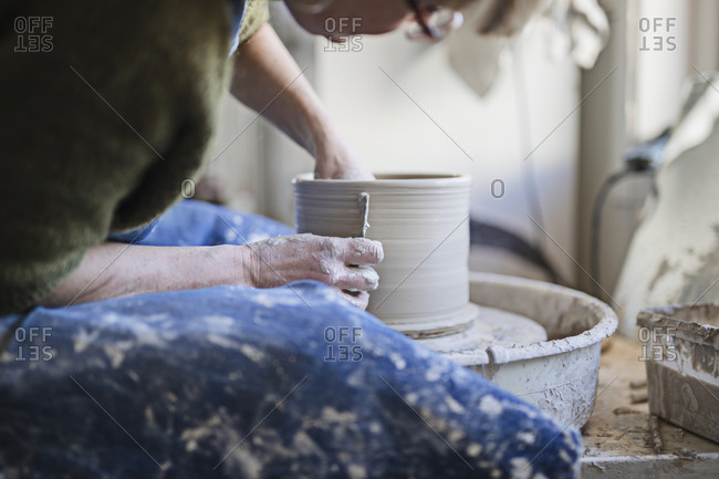 Potter using potters wheel - Offset