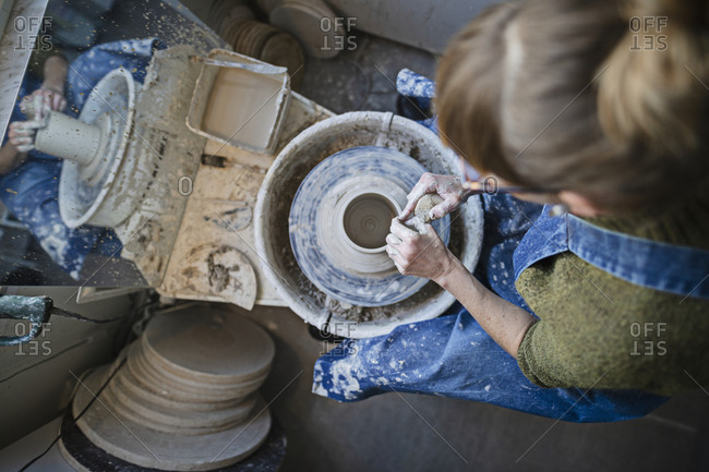 Potter using potters wheel - Offset