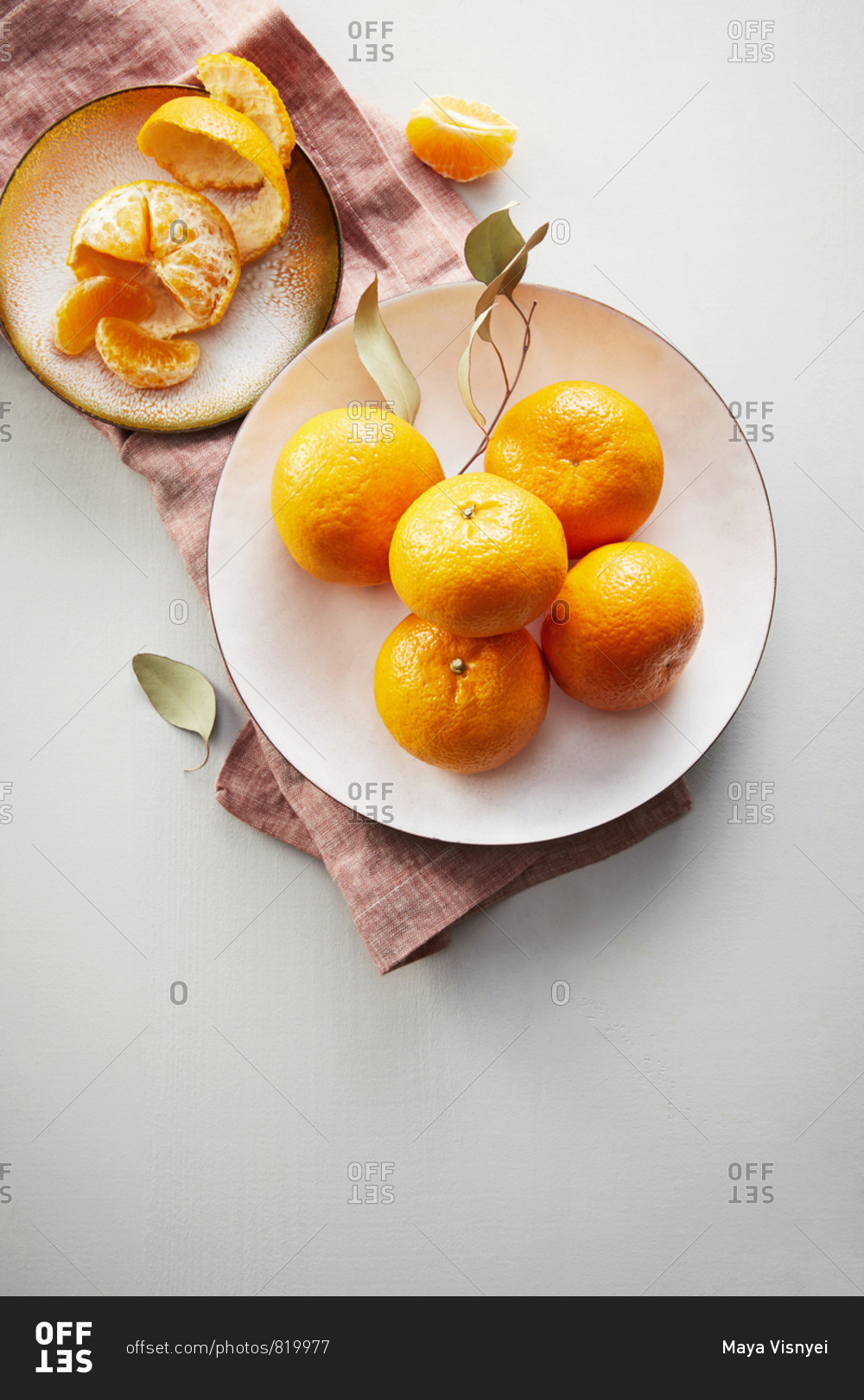 Overhead view of fresh clementines on a white counter stock photo OFFSET
