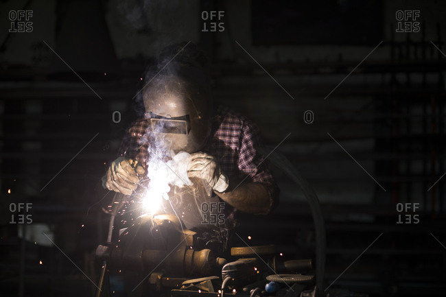 Man welding in his workshop