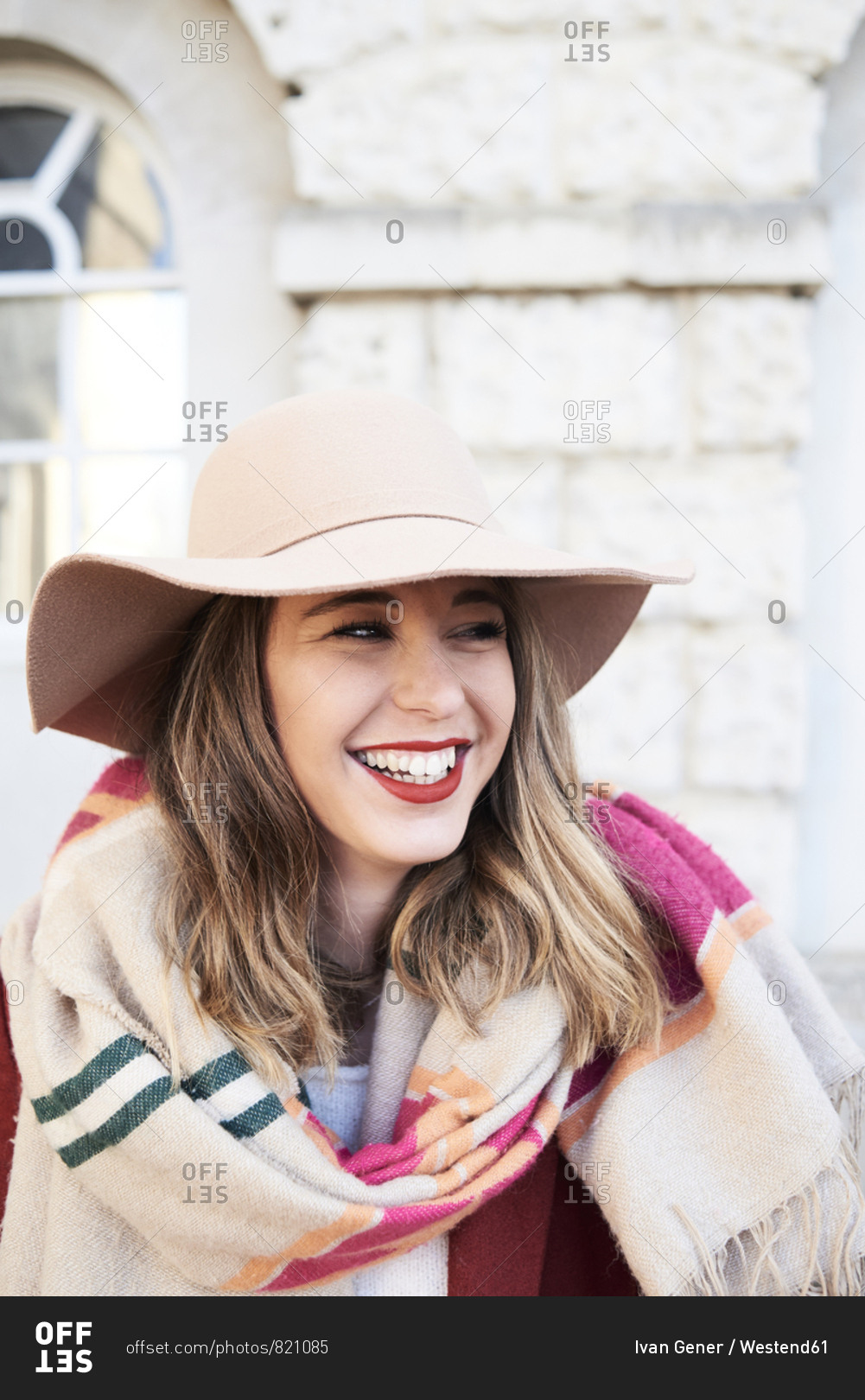Portrait of a smiling stylish woman wearing a floppy hat