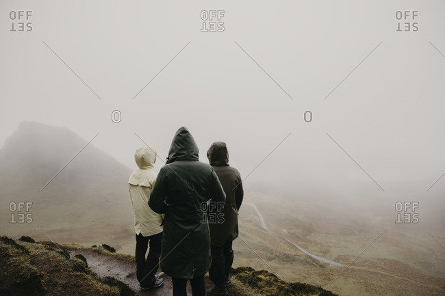 UK- Scotland- Isle of Skye- Quiraing Viewpoint- rear view of three women in foggy landscape