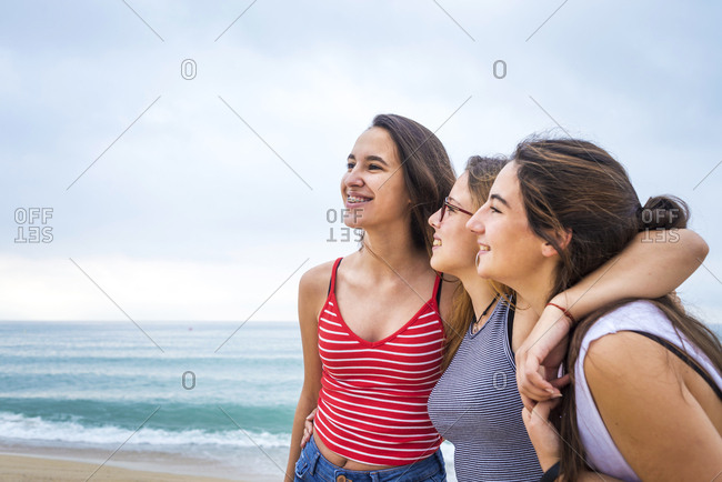Group of young female friends having fun on the beach