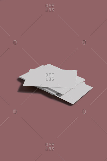 From above white business card stack template placed on brown background
