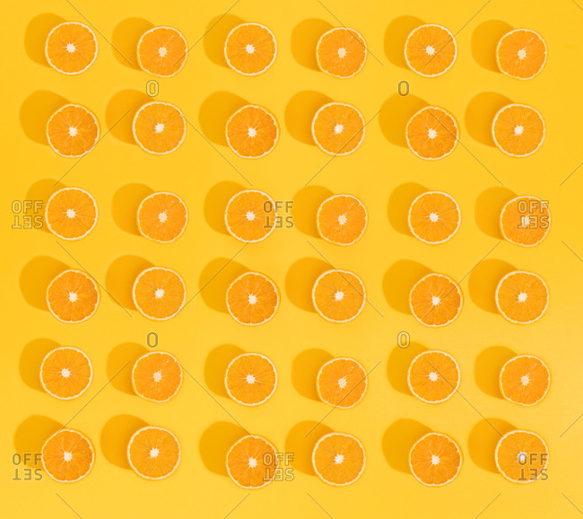 Set of beautiful wallpaper with sliced oranges on bright yellow background.