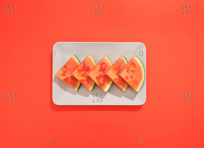Summer juicy fruit watermelon slices in red background from above