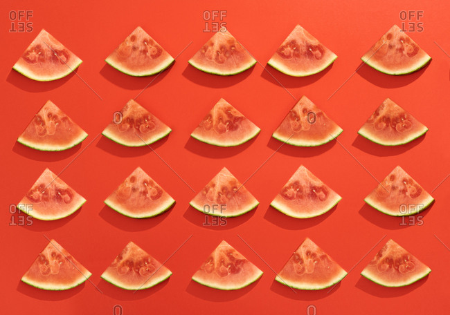 Summer juicy fruit watermelon slices in red background from above