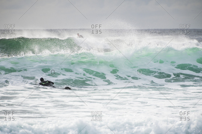 Surfer exploring coastal Ireland on a surf trip