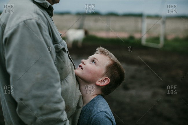 Boy hugging his father outdoors