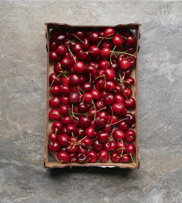 Overhead view of box of ripe cherries