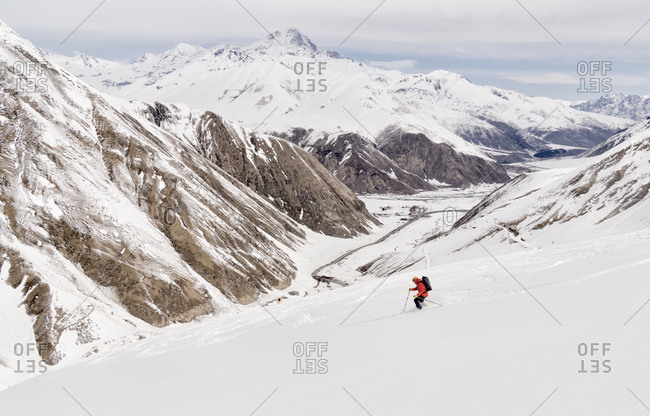 Georgia- Caucasus- Gudauri- man on a ski tour riding downhill