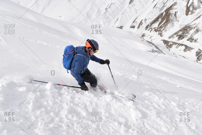 Georgia- Caucasus- Gudauri- man on a ski tour riding downhill