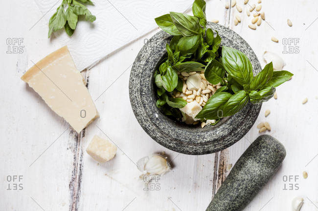 Preparing pesto alla genovese with mortar