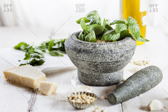 Preparing pesto alla genovese with mortar