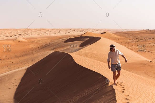 Man walking on a sand dune- Wahiba Sands- Oman