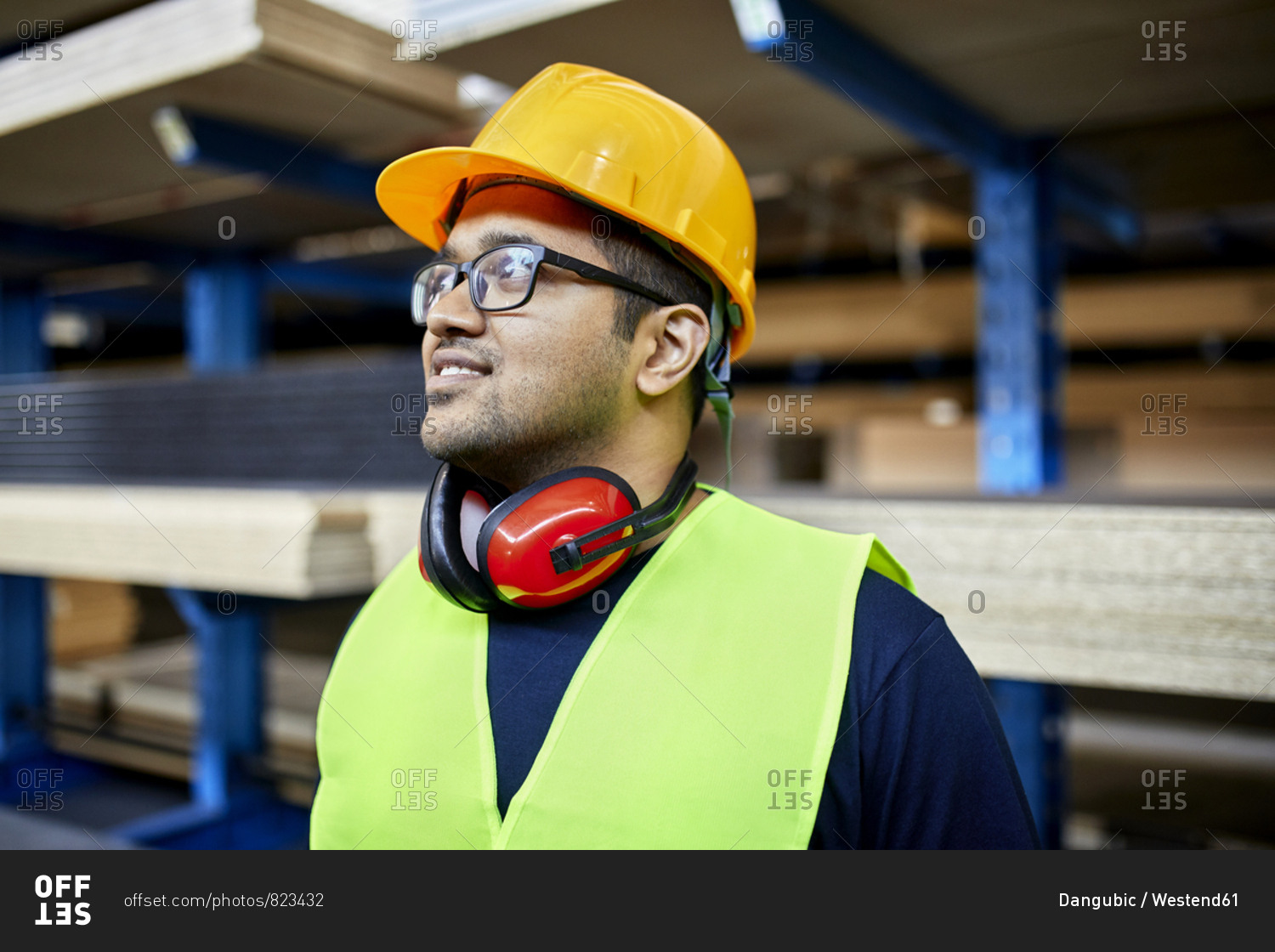Portrait of smiling worker in factory warehouse