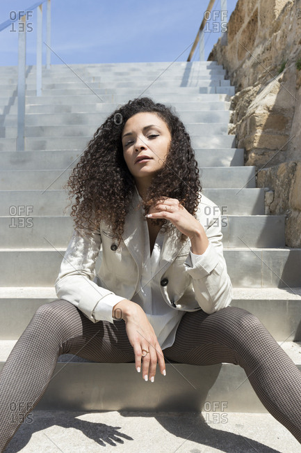 Fashion portrait of beautiful brunette on stairs
