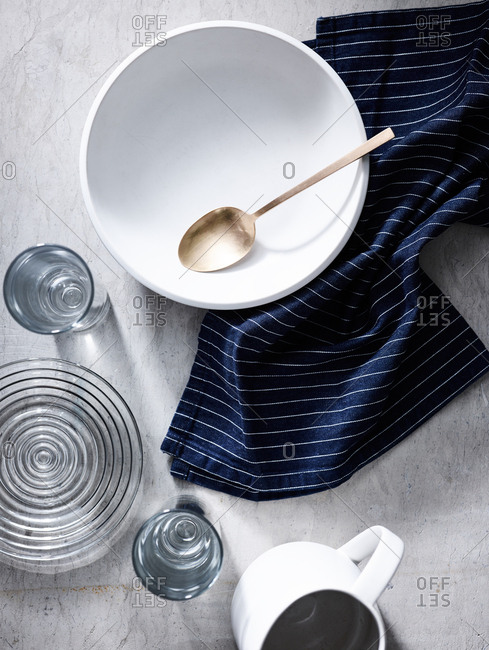 Overhead view of dishes and towel on light background