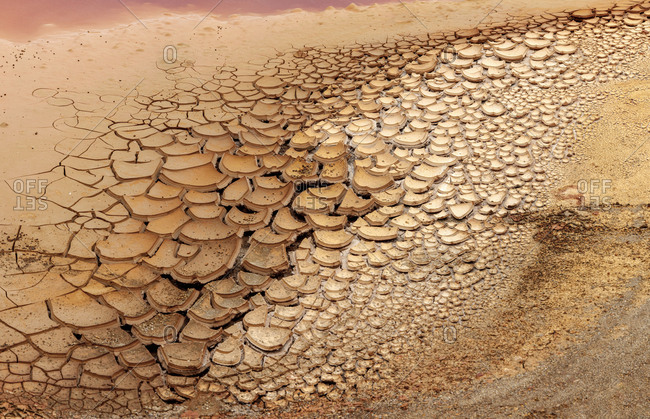 From above dry brown rock surface in cracks